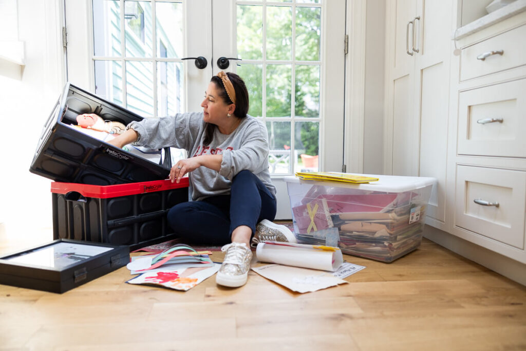 Mom Kiera Liu with boxes of kids artwork