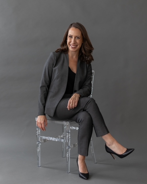 diana perkins headshot sitting on clear chair in gray powersuit teaching beginners how to invest