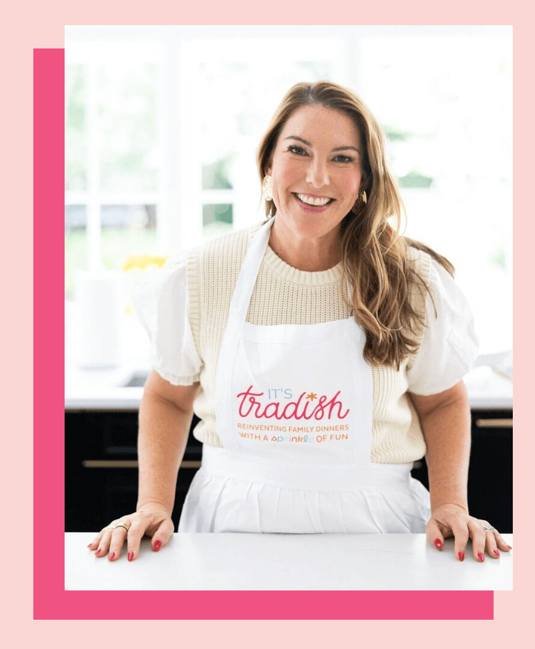 Alix Mackey, founder of It's Tradish standing in her kitchen wearing an apron headshot