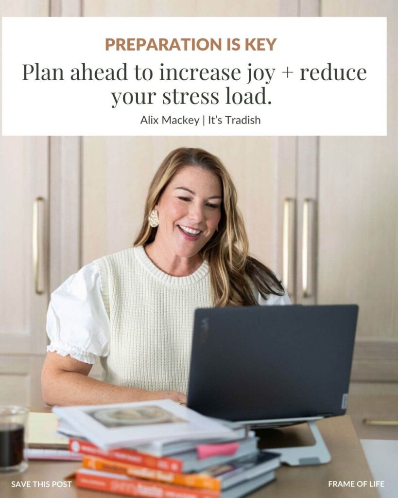 Alix Mackey, founder of It's Tradish sitting at a computer with cookbooks and paper spread out in front of her planning her week with a text box that says: Preparation is Key: Plan ahead to increase joy and reduce your stress load