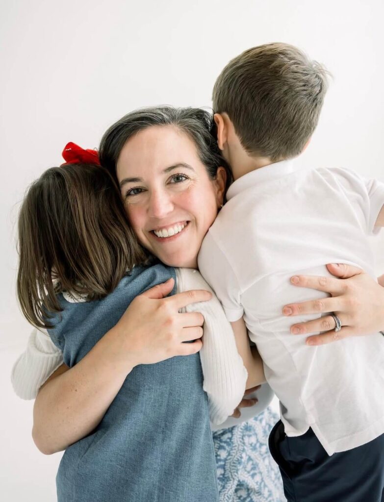 Ellie Rineck hugging her kids